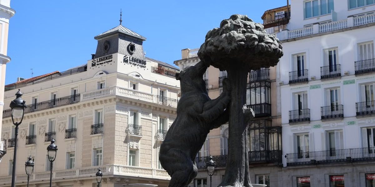 Iconic Bear and Strawberry Tree statue in Madrid's bustling Puerta del Sol.